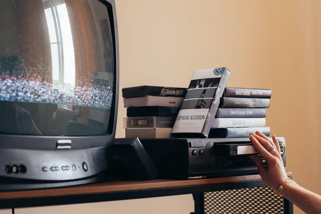 Vintage scene with a VHS player, tapes, and an old CRT TV creating a nostalgic vibe. Checking whether an ad appeared on a television device